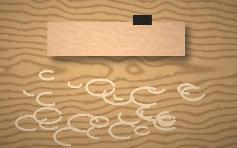 Rabot posé sur une planche avec des copeaux