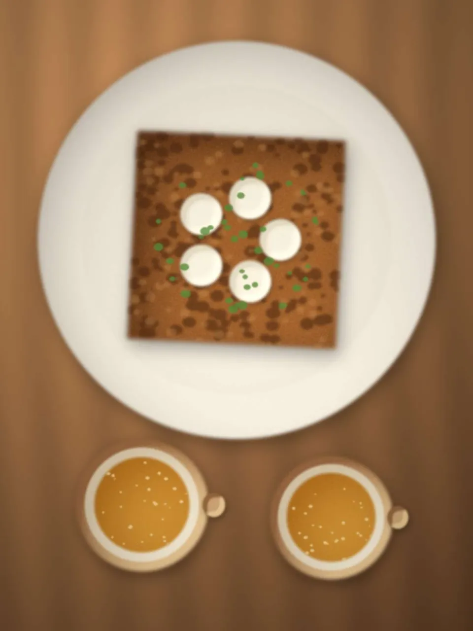 Galette au chèvre et deux bolées de cidre sur une table en bois